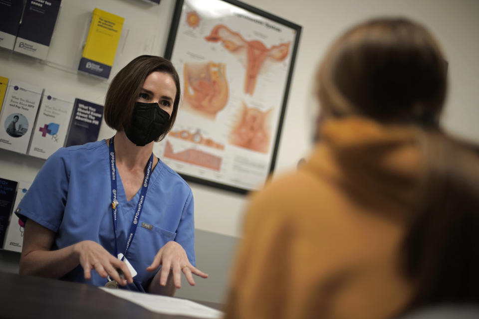 Dr. Elizabeth Brett Daily talks with patient Haley Ruark about the medical abortion process at a Planned Parenthood clinic Wednesday, Oct. 12, 2022, in Kansas City, Kan. (AP Photo/Charlie Riedel)