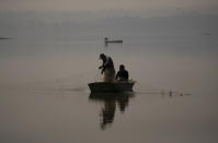 Fishermen fish in the waters of the Villa Victoria Dam, the main water supply for Mexico City residents, on the outskirts of Toluca, Mexico Thursday, April 22, 2021. Drought conditions now cover 85% of Mexico, and in areas around Mexico City and Michoacán, the problem has gotten so bad that lakes and reservoirs are drying up. (AP Photo/Fernando Llano)