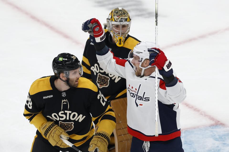 Washington Capitals' Anthony Mantha, right, celebrates beside Boston Bruins' Derek Forbort (28) after the goal by Garnet Hathaway on Jeremy Swayman, behind, during the second period of an NHL hockey game, Saturday, Feb. 11, 2023, in Boston. (AP Photo/Michael Dwyer)