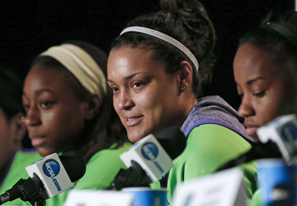 Notre Dame guard Kayla McBride, center, answers questions during a news conference at the NCAA women's Final Four college basketball tournament Monday, April 7, 2014, in Nashville, Tenn. Notre Dame is scheduled to face Connecticut in the championship game Tuesday. (AP Photo/John Bazemore)