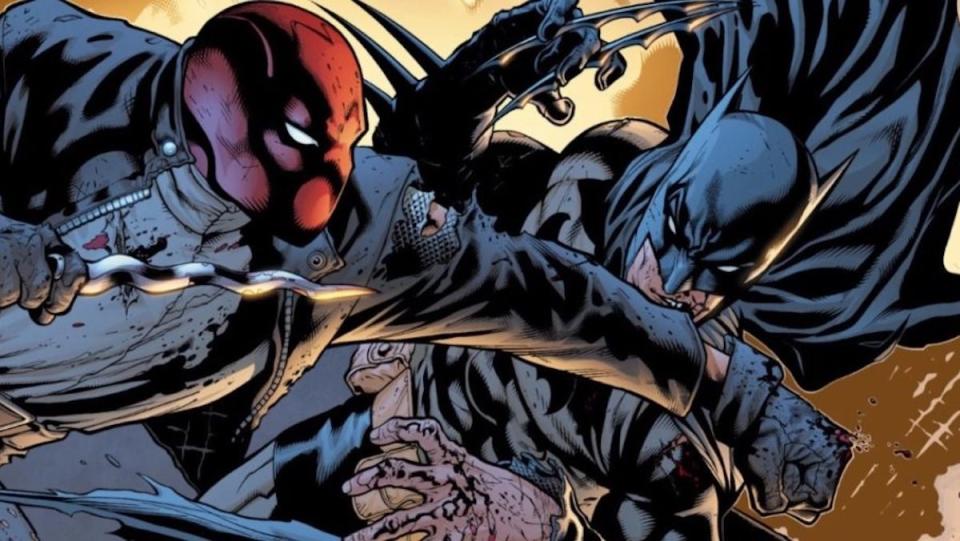 The Red Hood punches Batman