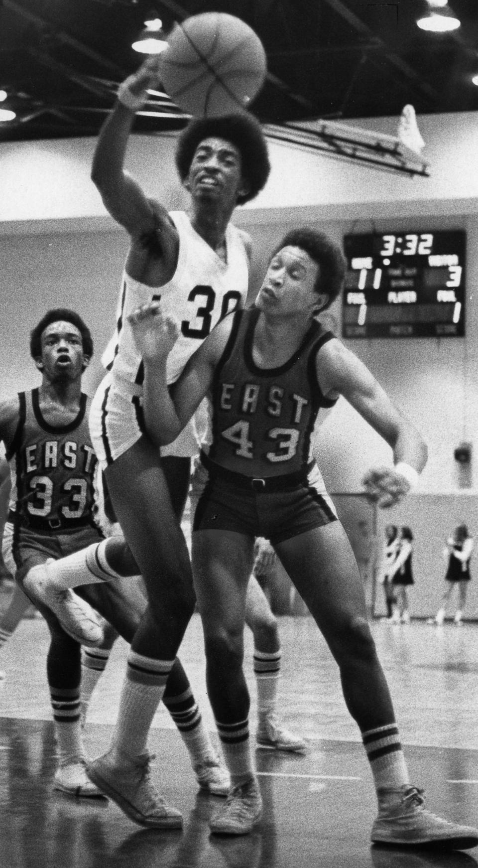 Former Buchtel basketball player Eugene "Gene" Shy Jr., left, fights for a rebound against Mike Holmes of East during a game on Feb. 24, 1971, in Akron.
