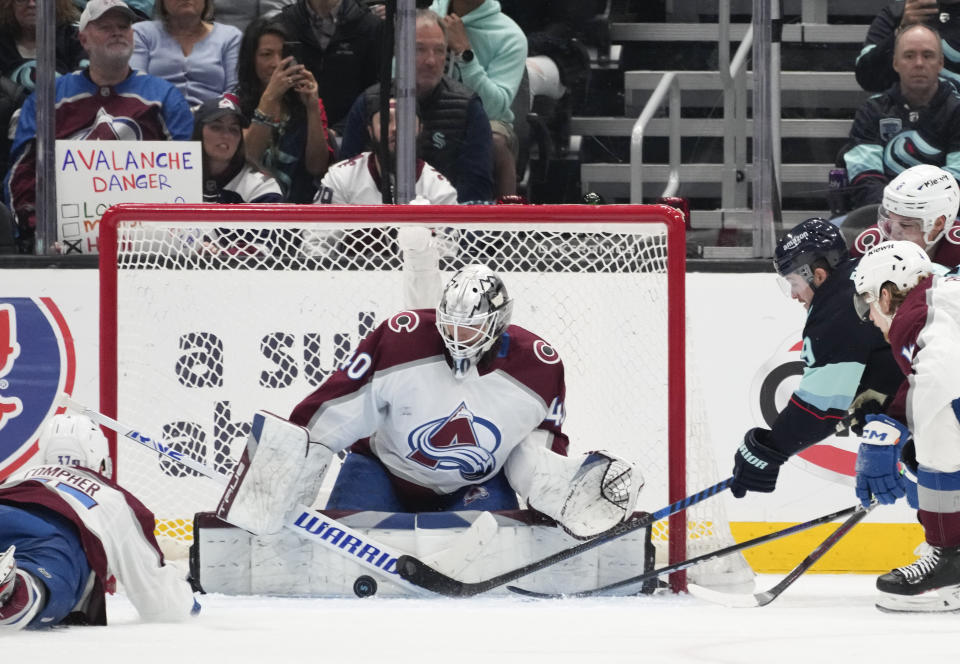 Colorado Avalanche goaltender Alexandar Georgiev (40) makes a block against Seattle Kraken center Ryan Donato (9) during the second period of Game 4 of an NHL hockey Stanley Cup first-round playoff series Monday, April 24, 2023, in Seattle. (AP Photo/Lindsey Wasson)