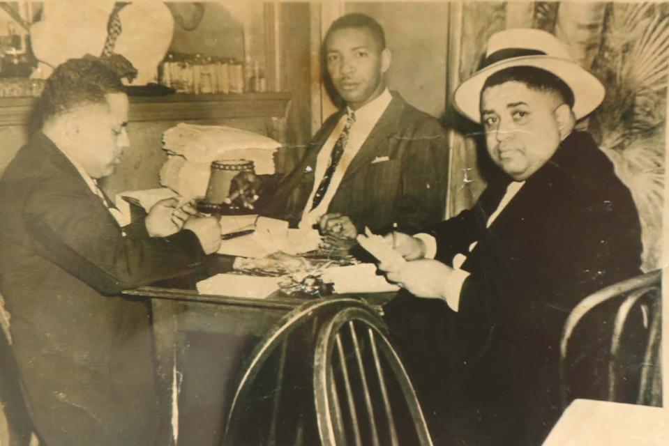 Homell Calhoun Sr., center, owner of the Calhoun Record Shop, sits with friends Johnny Moore, left, and Booker Brooks in the 1950s.