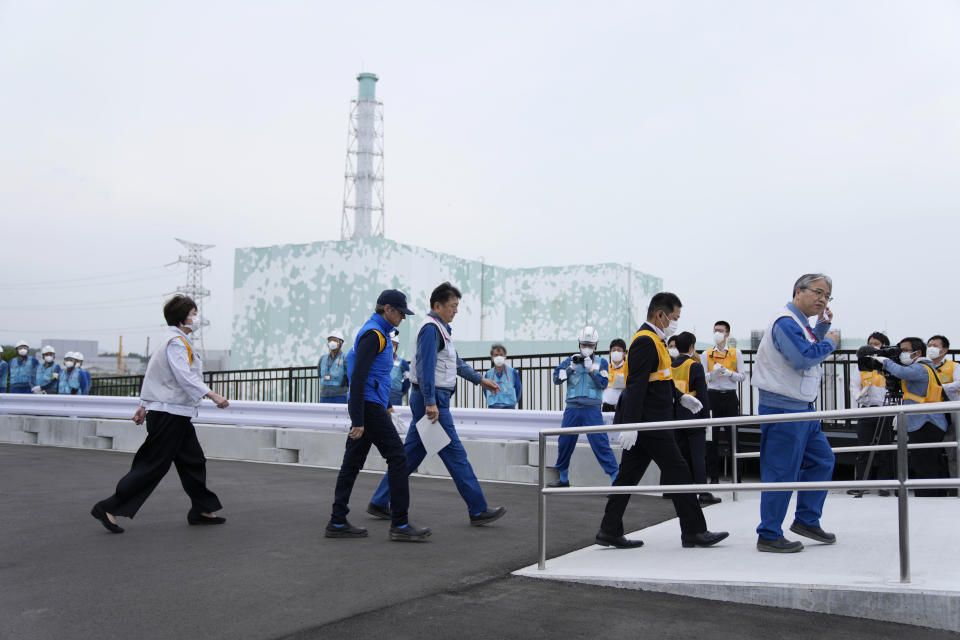 Rafael Mariano Grossi, Director General of the International Atomic Energy Agency, second left, arrives to inspect the damaged Fukushima nuclear power plant as Tomoaki Kobayakawa, President of Tokyo Electric Power Co., third left, escorts him in Futaba, northeastern Japan, Wednesday, July 5, 2023. Japan's Vice Industry Minister Fusae Ota, left, follows. (AP Photo/Hiro Komae, Pool)