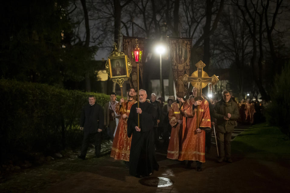 Lithuanian Orthodox priests and believers walk in the Easter procession at the Orthodox Church of the Holy Spirit in Vilnius, Lithuania, shortly after midnight, Sunday, April 16, 2023. (AP Photo/Mindaugas Kulbis)