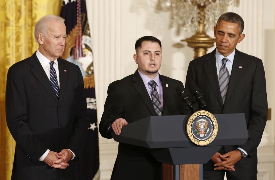 U.S. President Obama and Vice President Biden listen to apprentice electrician Varela of Pacific Gas and Electric discuss his previous unemployment , in East Room of White House in Washington