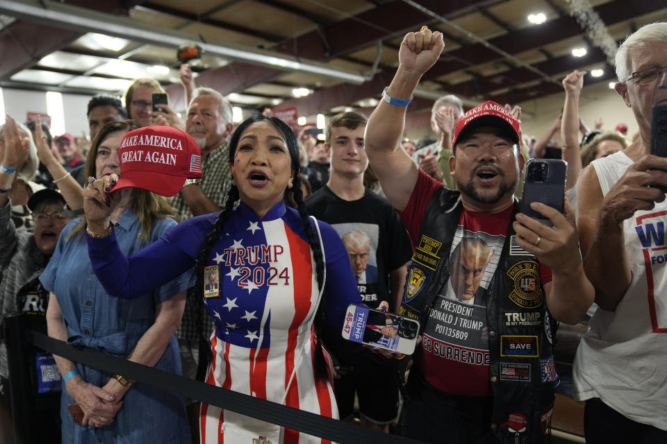 Supporters cheer for former President Donald Trump as he speaks during a commit to caucus rally, Wednesday, Sept. 20, 2023, in Maquoketa, Iowa. (AP Photo/Charlie Neibergall)