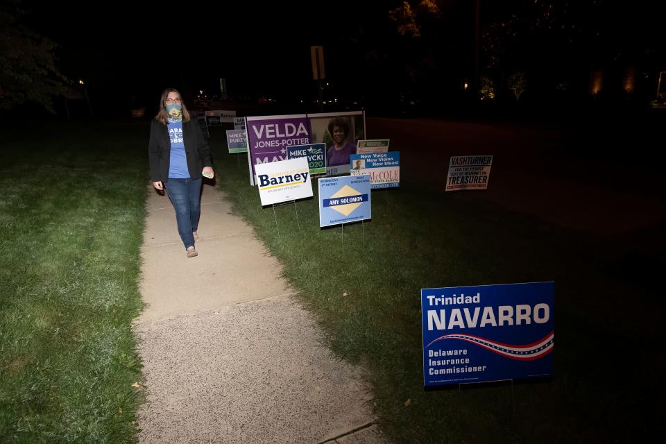 Transgender activist Sarah McBride is shown here walking near campaign signs in September, a few months before winning a state Senate seat in Delaware.