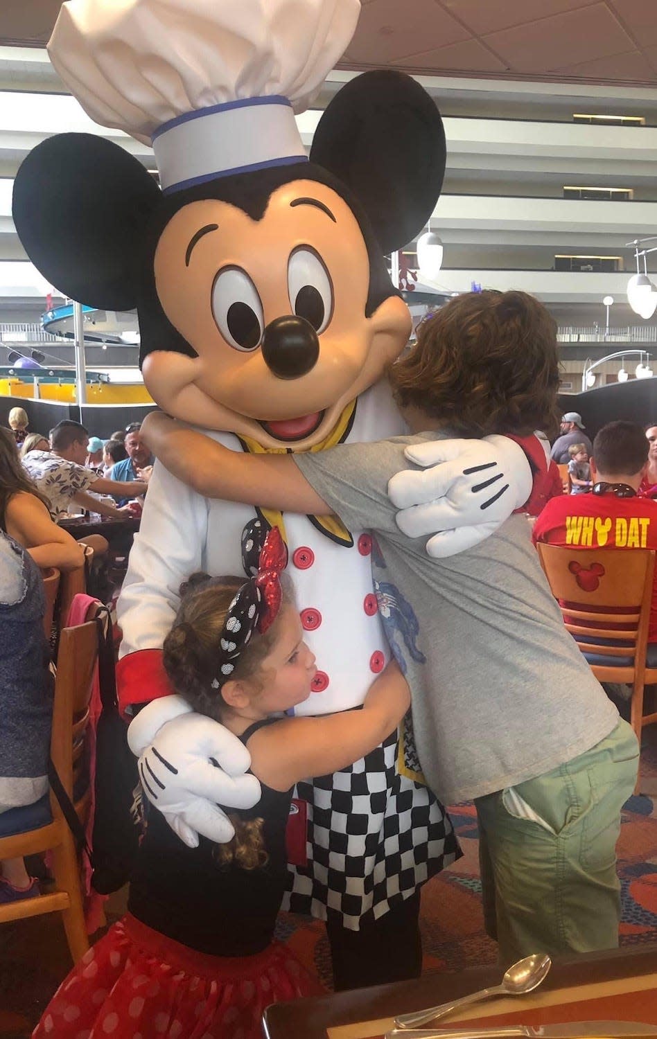 Kathryn's Finkelstein's kids hug Mickey, and her daughter wears a pair of Minnie Mouse ears.