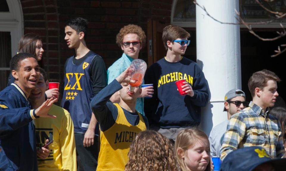 Students at the University of Michigan gather at the Sigma Chi fraternity house to drink alcohol.