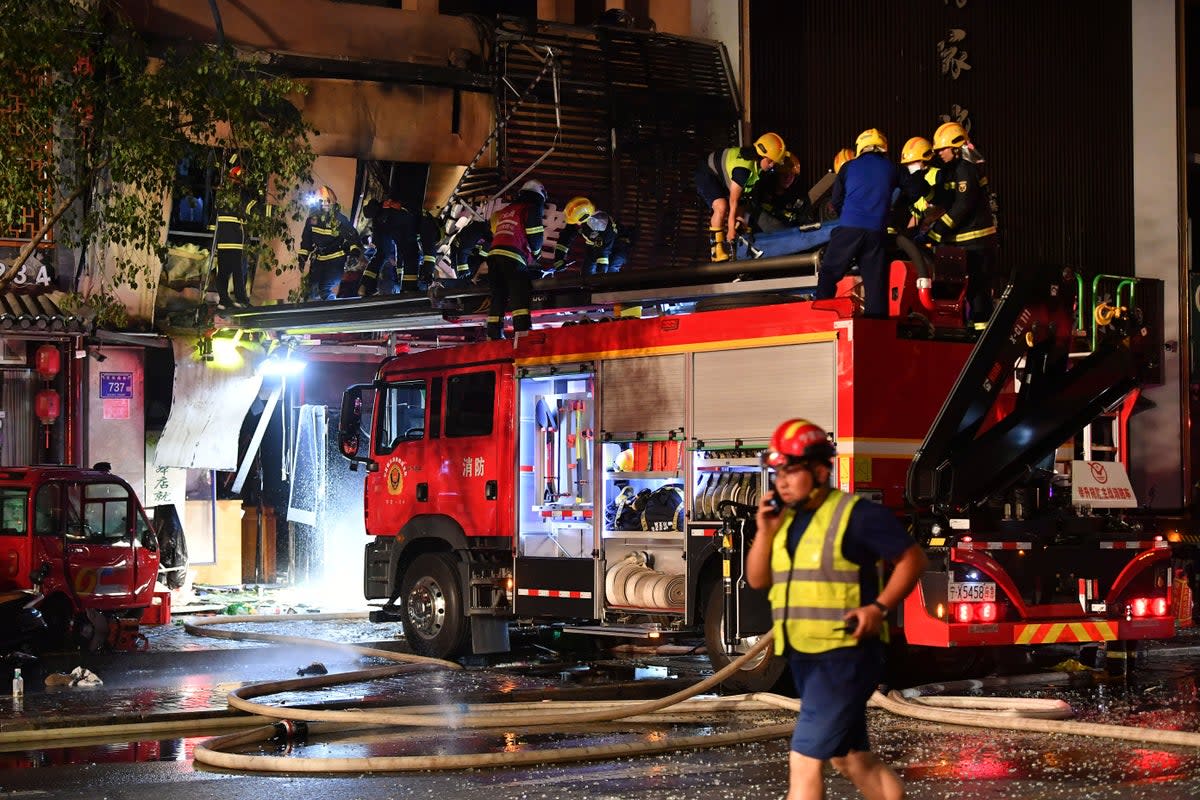 Smoke rises from a building following a gas explosion at a barbecue restaurant in Yinchuan city, Ningxia (AP)