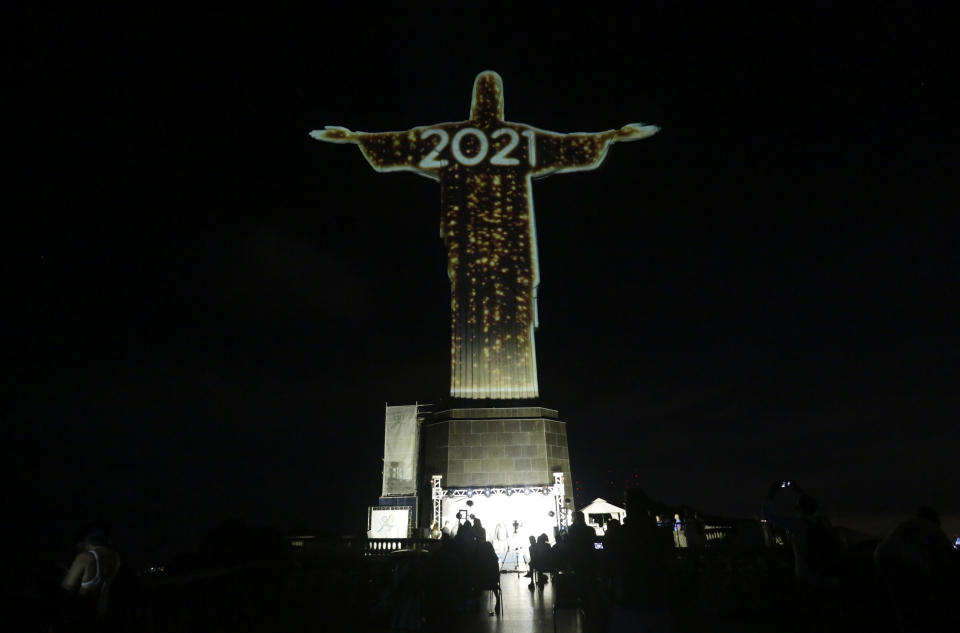 The iconic Christ the Redeemer statue is lit up during a New Year's Eve celebration in Rio de Janeiro, Brazil, Thursday, Dec. 31, 2020. (AP Photo/Bruna Prado)