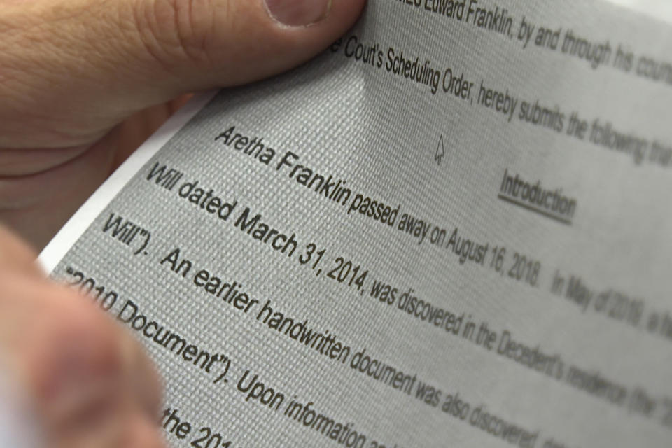 In a frame grab from video, Pat Simasko, an attorney who specializes in wills and estates and teaches elder law at Michigan State University College of Law, holds a copy of a court filing in the case of the estate of Aretha Franklin, June 29, 2023 in Mount Clemens, Mich. Five years after her death, the final wishes of the music superstar are still unsettled. The latest: an unusual trial next Monday to determine which handwritten will, including one found in couch cushions, will guide how her estate is handled. (AP Photo/Mike Householder)