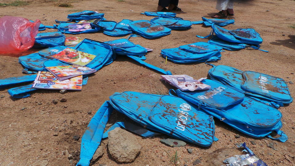 Children's backpacks lie at the site a day after an airstrike in Saada, Yemen on Friday, Aug. 10, 2018. Yemen's Shiite rebels are backing a United Nations' call for an investigation into a Saudi-led coalition airstrike in the country's north that killed dozens of people the previous day, including many children.(AP Photo/Kareem al-Mrrany)