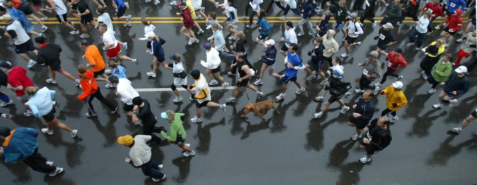 Half-marathon and 8-kilometer participants run along Forest Avenue in front of Drake Stadium during the Drake on the Road event of the Drake Relays on Saturday, April 28, 2006.