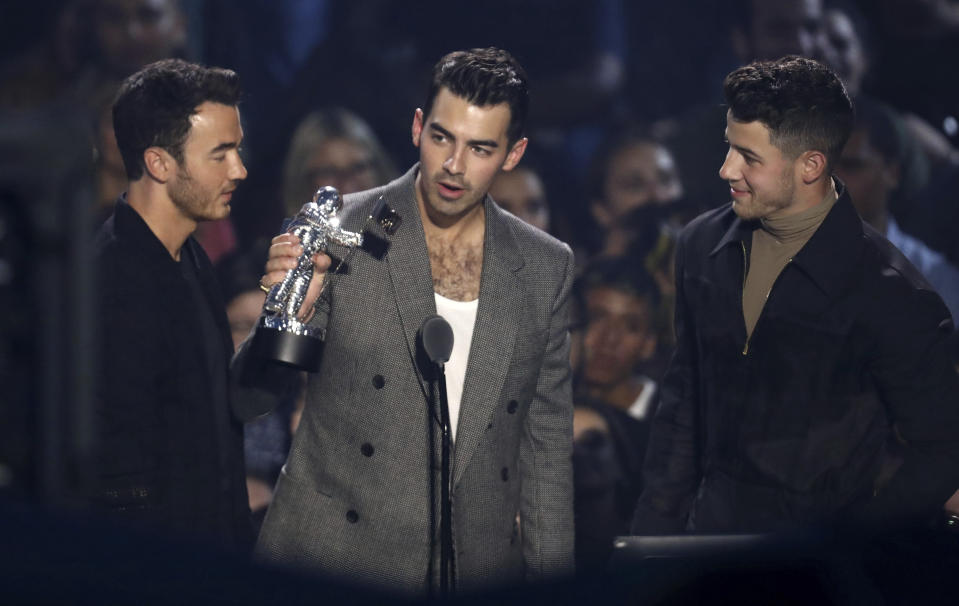 Kevin Jonas, from left, Joe Jonas and Nick Jonas, of the Jonas Brothers accept the best pop award for "Sucker" at the MTV Video Music Awards at the Prudential Center on Monday, Aug. 26, 2019, in Newark, N.J. (Photo by Matt Sayles/Invision/AP)