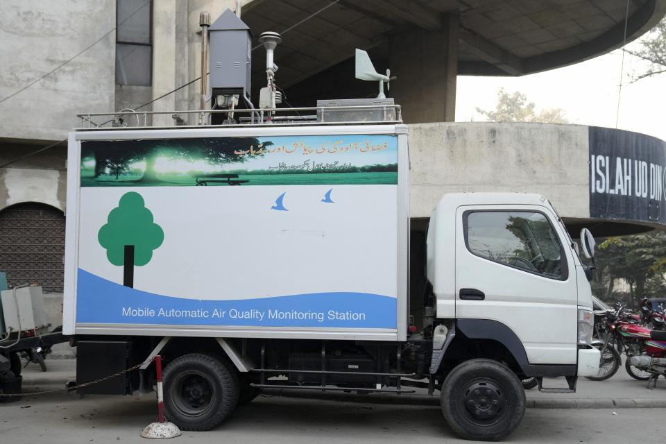 A mobile automatic air quality monitoring station is parked outside the main office of the Punjab's Environment Protection Department, in Lahore, Pakistan, Wednesday, Jan. 10, 2024. Toxic smog has sickened tens of thousands of people in recent months. Flights have been canceled. Artificial rain was deployed last December to battle smog, a national first. Nothing seems to be working. (AP Photo/K.M. Chaudary)