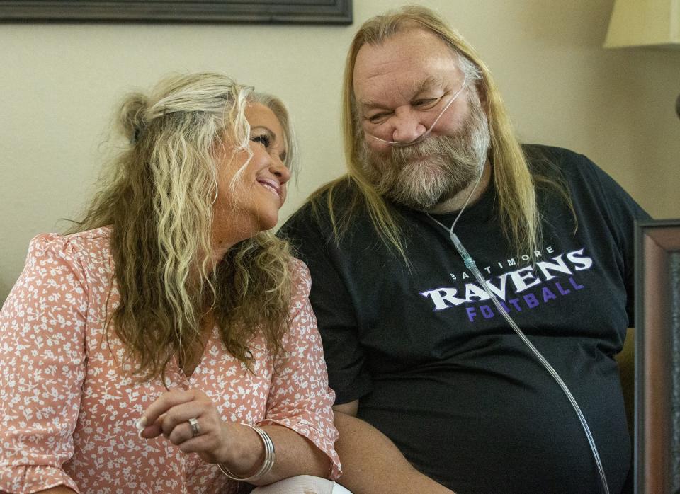 Stacey Ellsworth leans into her husband Stan Ellsworth&nbsp;at their home.