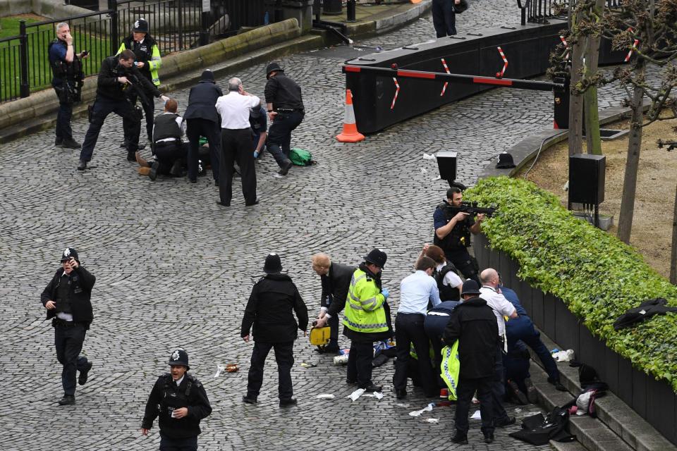 Emergency services at the scene outside the Palace of Westminster after policeman Keith Palmer was stabbed and his attacker shot - Credit: PA