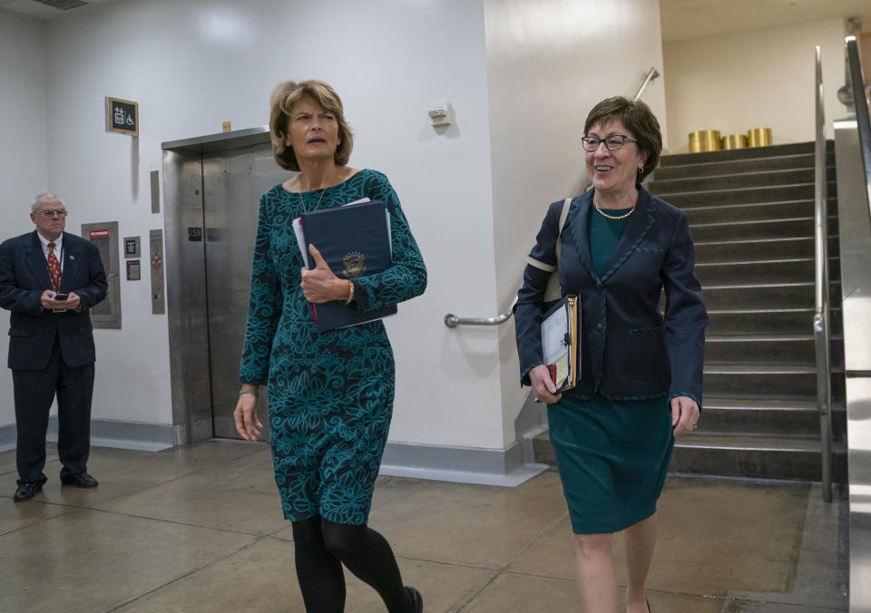 Sen. Lisa Murkowski, R-Alaska, left, and Sen. Susan Collins, R-Maine, walk together following a vote at the Capitol in Washington, Wednesday, Feb. 12, 2020. (AP Photo/J. Scott Applewhite)
