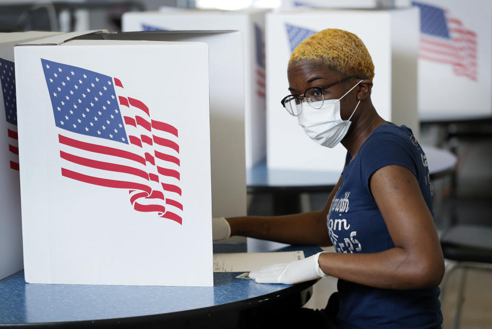 Princess Walker, of Des Moines, Iowa, fills out her ballot in Iowa's Primary Election at the Polk County Central Senior Center, Tuesday, June 2, 2020, in Des Moines, Iowa. (AP Photo/Charlie Neibergall)