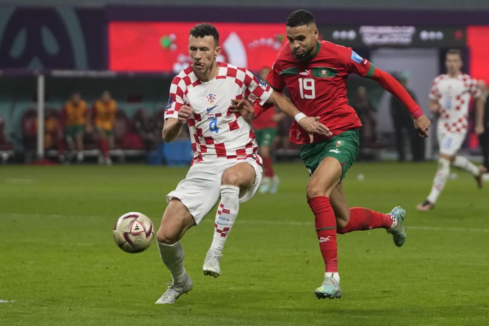 Croatia's Ivan Perisic, left, and /mo19, fight for the ball during the World Cup third-place playoff soccer match between Croatia and Morocco at Khalifa International Stadium in Doha, Qatar, Friday, Dec. 16, 2022. (AP Photo/Thanassis Stavrakis)