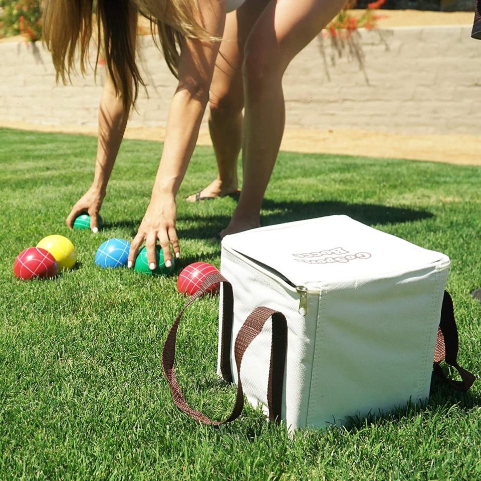 This game will give you hours of backyard play with the fam on sunny days. Bonus: You'll also get a killer arm and wrist workout. <br /><br /><strong>Promising review:</strong> "We have had a few other bocce sets and this one is by far the best. The balls are solid, not water filled, like some others. <strong>The balls are a good size, nice weight, and the finish is durable. We like the carrying case as well as the rope for measuring, both of these were additional features that we didn't receive with previous (other brand) sets.</strong> We use the set in our backyard and its been great!" &mdash; <a href="https://amzn.to/3dGr1pa" target="_blank" rel="nofollow noopener noreferrer" data-skimlinks-tracking="5580838" data-vars-affiliate="Amazon" data-vars-href="https://www.amazon.com/gp/customer-reviews/R122M6AHO70OS7?tag=bfgenevieve-20&amp;ascsubtag=5580838%2C9%2C33%2Cmobile_web%2C0%2C0%2C1159989" data-vars-keywords="cleaning,fast fashion" data-vars-link-id="1159989" data-vars-price="" data-vars-product-id="16176802" data-vars-retailers="Amazon">Amazon Customer</a><br /><br /><strong>Get it from Amazon for <a href="https://amzn.to/3tLJINM" target="_blank" rel="noopener noreferrer">$39.99+</a> (also available in a soft rubber ball set and a light-up LED ball set). </strong>