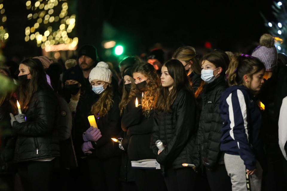 Community members gather during a vigil for Shirley Owen on the Town Common in Franklin on Dec. 19, 2021.