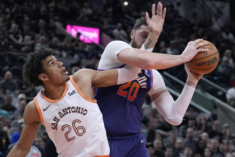 Phoenix Suns center Jusuf Nurkic (20) is defended by San Antonio Spurs forward Dominick Barlow (26) during the first half of an NBA basketball game in San Antonio, Monday, March 25, 2024. (AP Photo/Eric Gay)