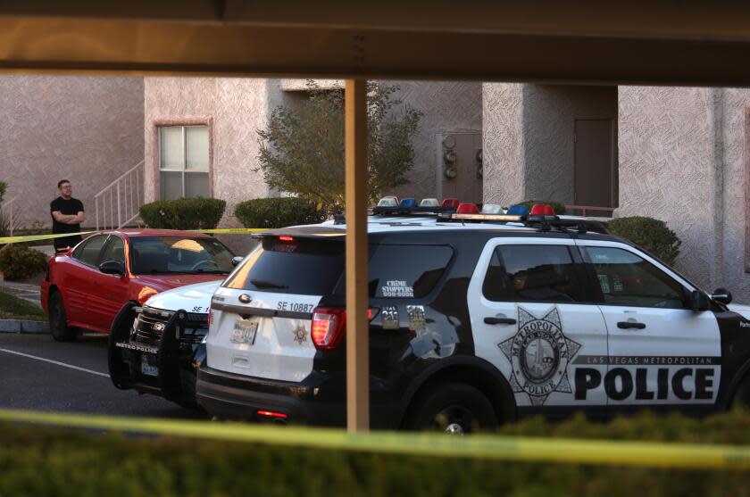 LAS VEGAS, NV - DECEMBER 7, 2023 - A tenant takes in the scene as police still stake out the complex where UNLV shooter Anthony Polito lived at the Promontory Point Apartments in Henderson a day after three died and one person injured in a mass shooting at the UNLV campus on December 7, 2023. (Genaro Molina / Los Angeles Times)