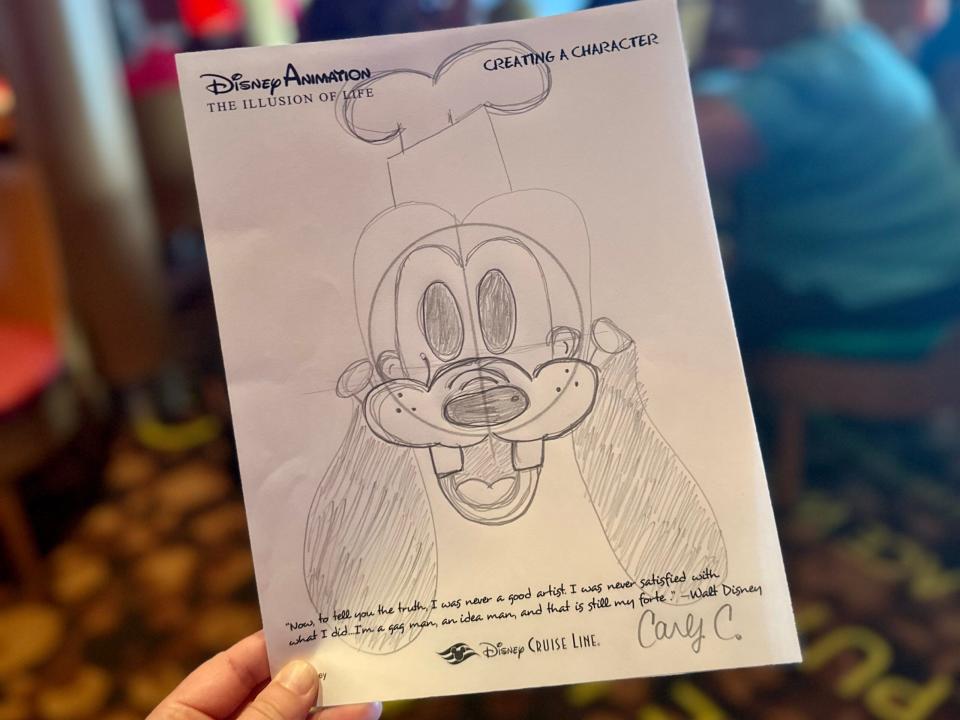 Carlys Bleistiftskizze von Goofy, mit einem Zitat von Walt Disney und ihrer Unterschrift auf dem Blatt.