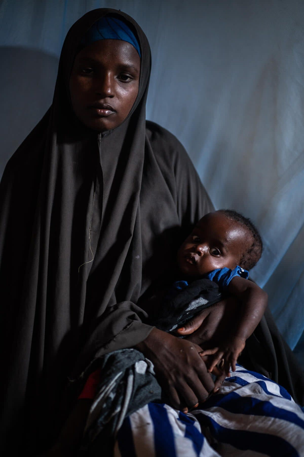 Mother-of-three Naima* was photographed sitting with her baby daughter Najma* in a stabilisation centre in Baidoa (Fredrik Lerneryd/Save the Children)