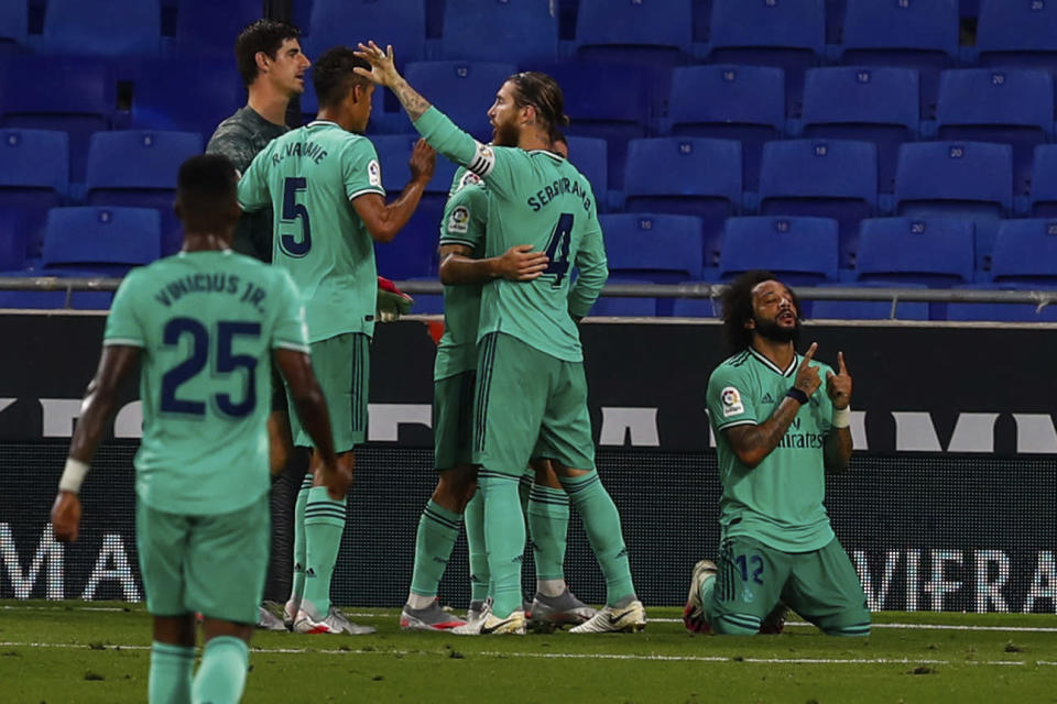 Real Madrid players celebrate their victory at the end of the Spanish La Liga soccer match against RCD Espanyol at the Cornella-El Prat stadium in Barcelona, Spain, Sunday, June 28, 2020. (AP Photo/Joan Monfort)