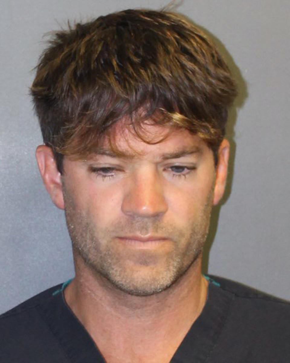 This undated booking photo provided by the Newport Beach, Calif., Police Department shows Grant W. Robicheaux, 38, a California doctor who appeared in a reality TV dating show. He and a woman co-defendant, Cerissa Laura Riley, 31, have been charged with drugging and sexually assaulting two women, and authorities suspect there may be many more victims. Orange County District Attorney Tony Rackauckas announced charges Tuesday, Sept. 18, 2018 against Robicheaux of Newport Beach and Riley of Brea. (Newport Beach Police Department via AP)