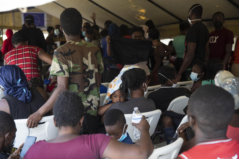 Haitian migrants deported from the US gather after arriving at the Toussaint Louverture International Airport in Port-au-Prince, Haiti, Sunday, Sept. 19, 2021. Thousands of Haitian migrants have been arriving to Del Rio, Texas, to ask for asylum in the U.S., as authorities begin to deported them to back to Haiti which is in a worse shape than when they left. (AP Photo/Rodrigo Abd)