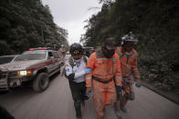 <p>Firefighters leave the evacuation area near Volcan de Fuego, or Volcano of Fire, in El Rodeo, Guatemala, June 3, 2018. (Photo: Santiago Billy/AP) </p>