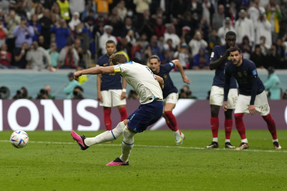 England's Harry Kane scores his side's opening goal during the World Cup quarterfinal soccer match between England and France, at the Al Bayt Stadium in Al Khor, Qatar, Saturday, Dec. 10, 2022. (AP Photo/Frank Augstein)