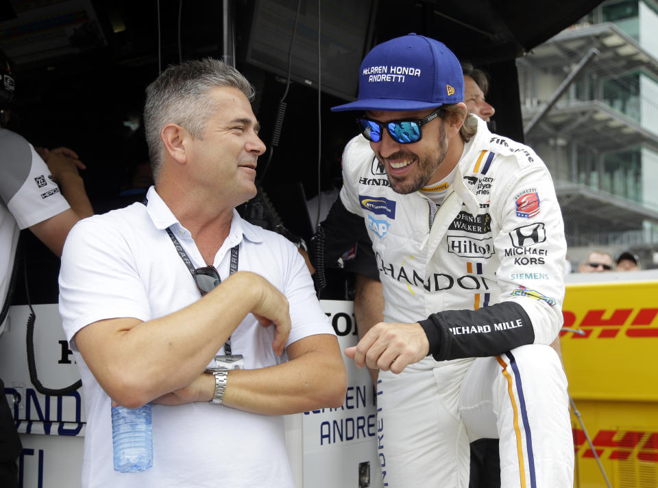 FILE - Fernando Alonso, right, of Spain, talks with Gil de Ferran during a practice session for the Indianapolis 500 IndyCar auto race at Indianapolis Motor Speedway, May 17, 2017, in Indianapolis. De Ferran, winner of the 1983 Indy 500 and holder of the closed-course land speed record, died Friday, Dec. 29, 2023, while racing with his son at The Concourse Club in Florida, multiple former colleagues confirmed to The Associated Press. He was 56. (AP Photo/Michael Conroy, File)