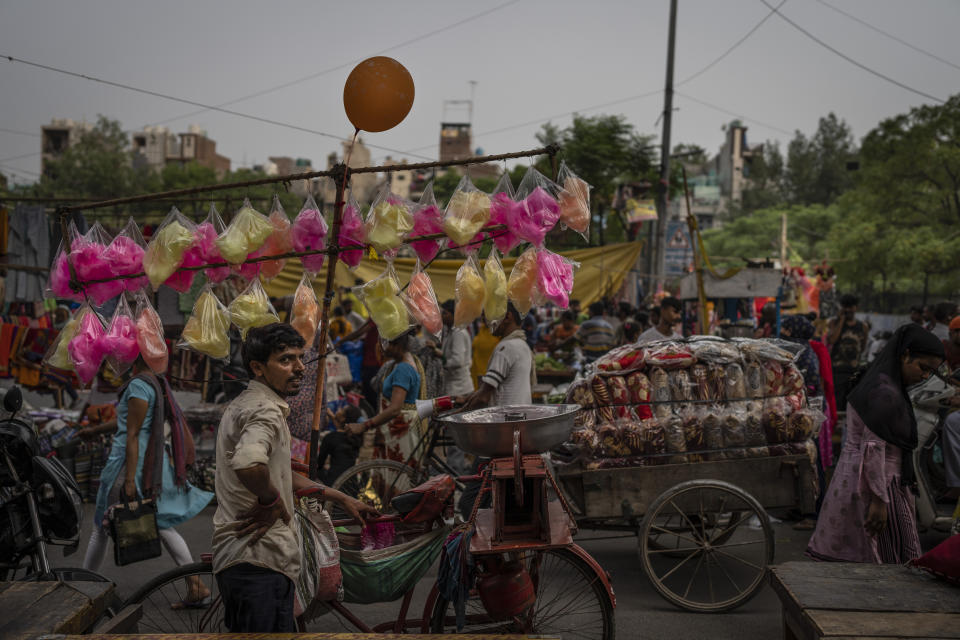 Cotton candies wrapped in plastic cover are displayed to woo customers at a weekly market in New Delhi, India, Wednesday, June 29, 2022. India banned some single-use or disposable plastic products Friday as a part of a longer federal plan to phase out the ubiquitous material in the nation of nearly 1.4 billion people. (AP Photo/Altaf Qadri)