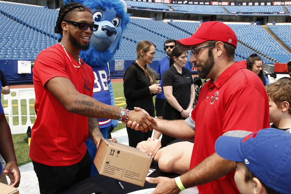 CAPTION CORRECTION: CORRECTS NAME SPELLING: Buffalo Bills defensive back Damar Hamlin hands out AEDs, (Automatic Electronic Defibrillator) to help resuscitate heart attack victims, to local community groups following the announcement of the first program of his Chasing M's Foundation, the Chasing M's Foundation CPR Tour, Saturday, June 3, 2023 in Orchard Park, N.Y. (AP Photo/Jeffrey T. Barnes)
