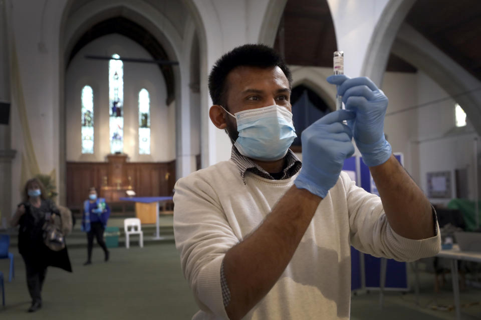 Pharmacist Rajan Shah prepares a syringe of the AstraZeneca vaccine at St John's Church, in Ealing, London, Tuesday, March 16, 2021. In recent days, countries including Denmark, Ireland and Thailand have temporarily suspended their use of AstraZeneca's coronavirus vaccine after reports that some people who got a dose developed blood clots, even though there's no evidence that the shot was responsible. The European Medicines Agency and the World Health Organization say the data available do not suggest the vaccine caused the clots.​ Britain and several other countries have stuck with the vaccine. (AP Photo/Kirsty Wigglesworth)