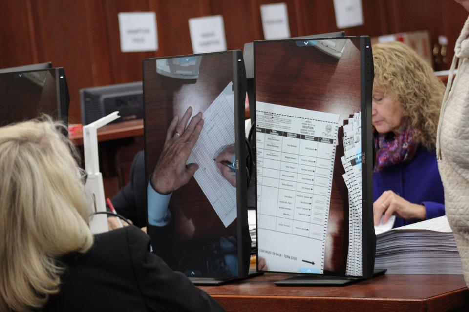 Debra Altschiller, the Democratic candidate who appears to have beaten Republican candidate Lou Gargiulo in the District 24 race for New Hampshire State Senate, watches Tuesday, Nov. 22, 2022, as workers review ballots from Hampton as part of a recount in the race.