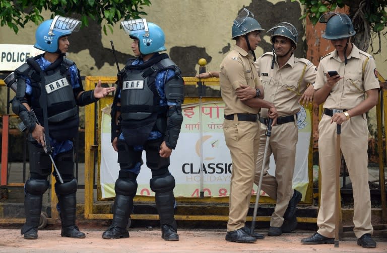 Rapid Action Force personnel and police stand guard outside the crematorium where the body of Yakub Memon, a key plotter of the Mumbai bomb attacks that killed hundreds of people in 1993, is expected to be buried in Mumbai on July 30, 2015