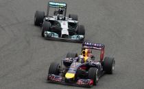 Red Bull Formula One driver Sebastian Vettel of Germany drives in front of Mercedes Formula One driver Nico Rosberg of Germany during the Chinese F1 Grand Prix at the Shanghai International circuit, April 20, 2014. REUTERS/Aly Song (CHINA - Tags: SPORT MOTORSPORT F1)