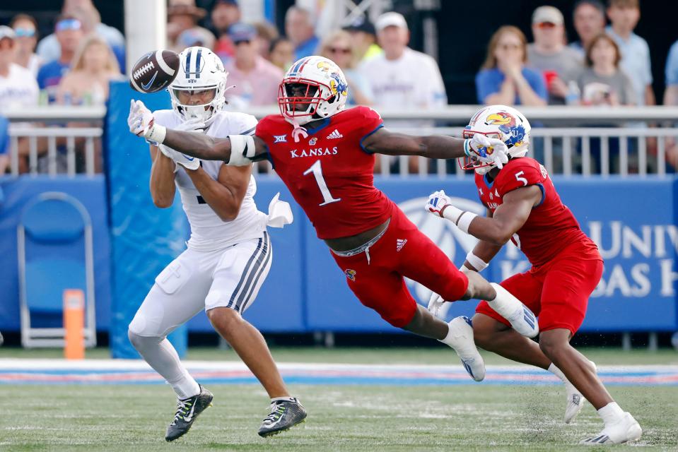 Kansas safety Kenny Logan Jr. (1) looks to stop a pass meant for BYU wide receiver Keanu Hill, left, as Kansas safety O.J. Burroughs (5) also defends during a game Sept. 23 in Lawrence.