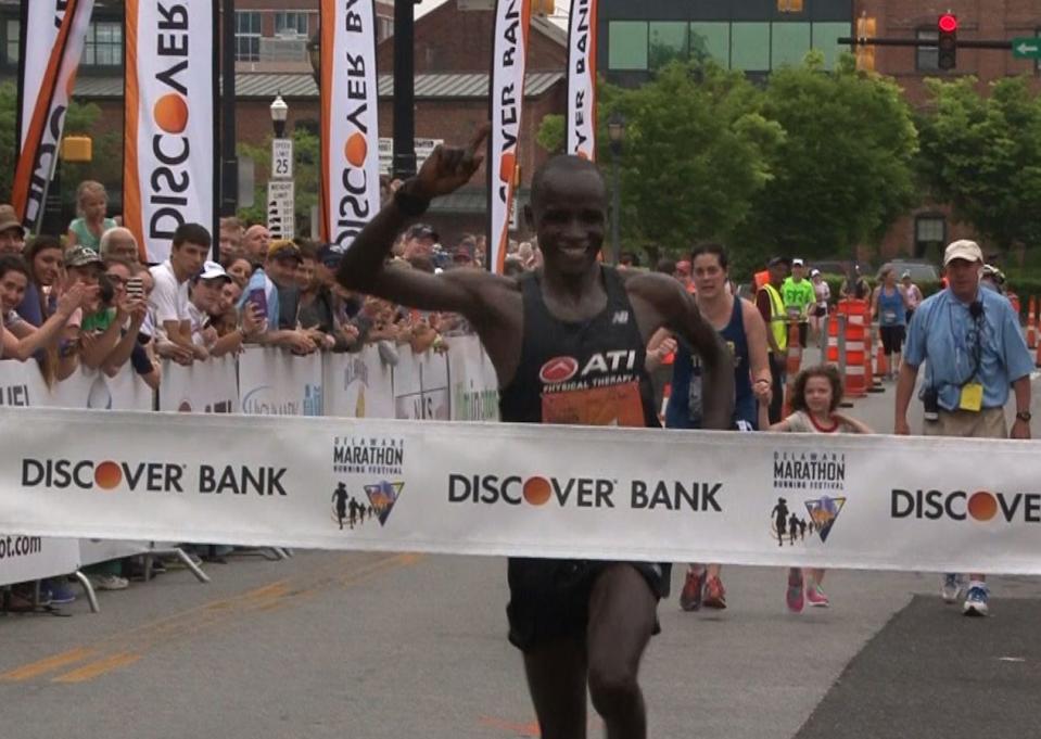 Titus Rotich, of Kenya, crosses the finish line to win the Delaware Marathon.