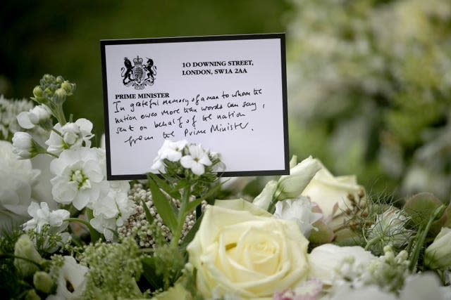 A wreath sent by prime Minister Boris Johnson among the flowers outside St George’s Chapel at Windsor Castle, Berkshire 