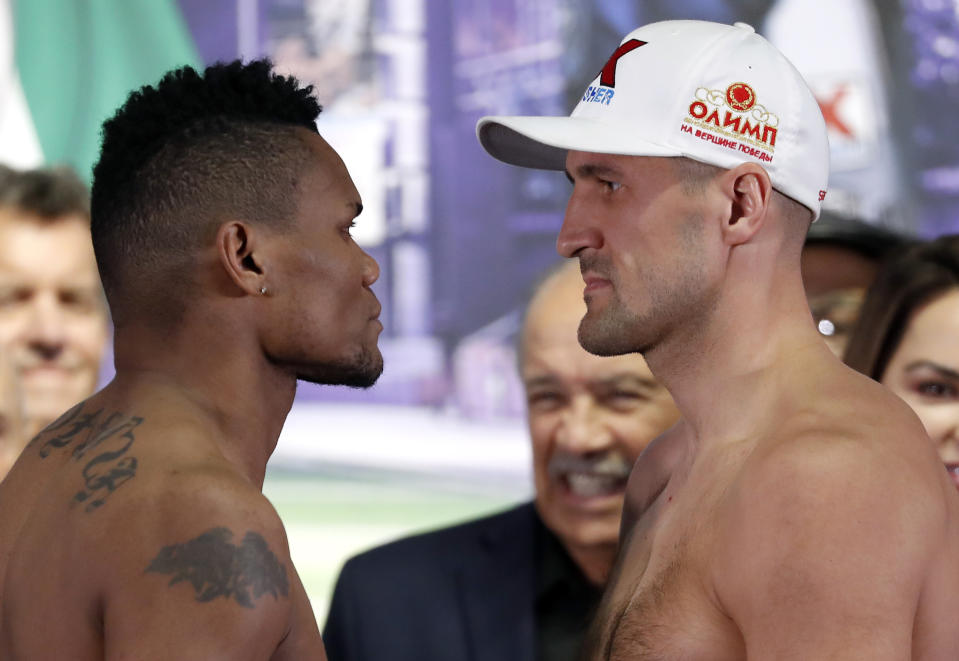 Eleider Alvarez, left, the WBO light heavyweight champion, and Sergey Kovalev, right, pose for photos after their weigh-ins in Frisco, Texas, Friday, Feb. 1, 2019. The two are scheduled to fight for the title Saturday. (AP Photo/Tony Gutierrez)