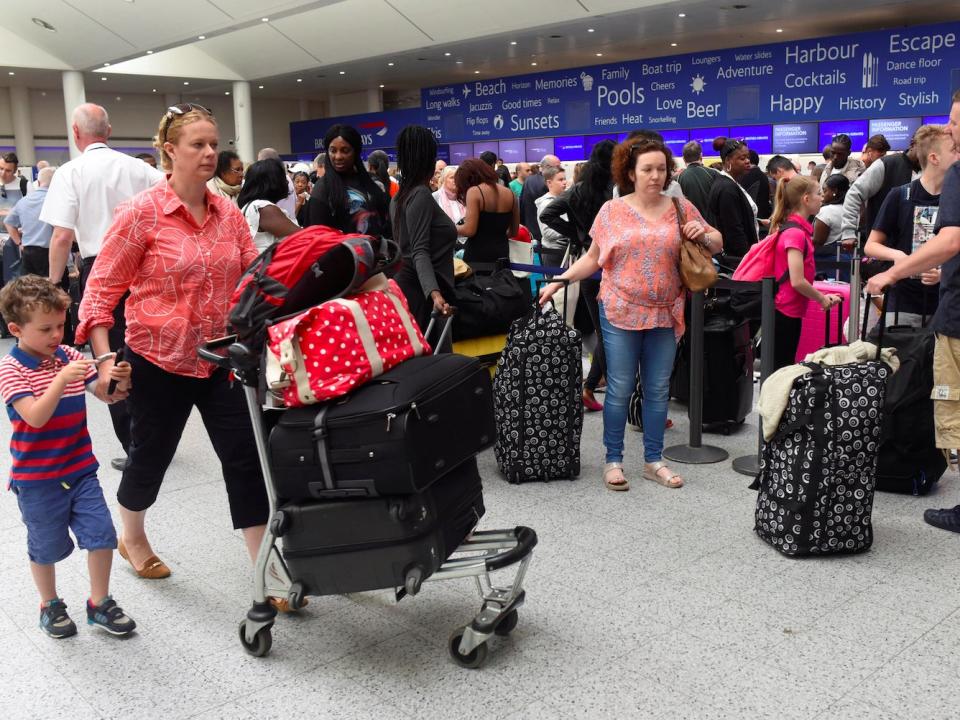 People queue with their luggage for the British Airways check-in desk at Gatwick Airport in southern England, Britain, May 28, 2017.